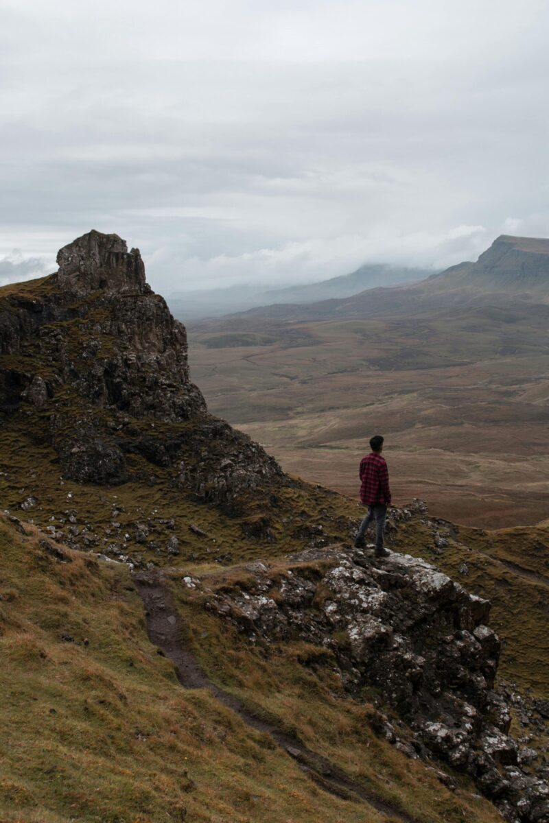 Traveler in a yellow jacket exploring the iconic Giant's Causeway in Northern Ireland.